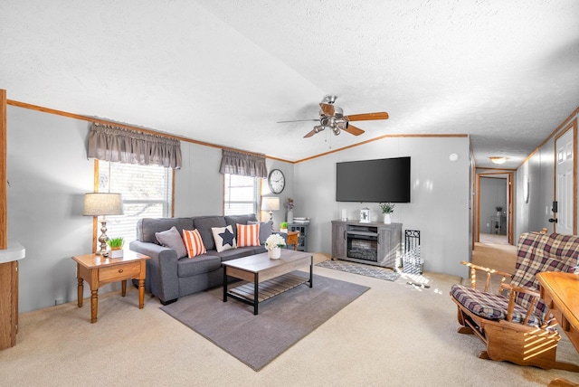 living area featuring light carpet, ornamental molding, a ceiling fan, a textured ceiling, and vaulted ceiling