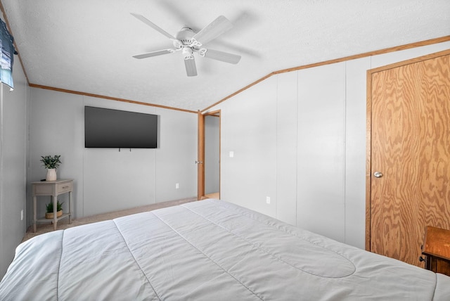 bedroom featuring a textured ceiling, a ceiling fan, lofted ceiling, and ornamental molding