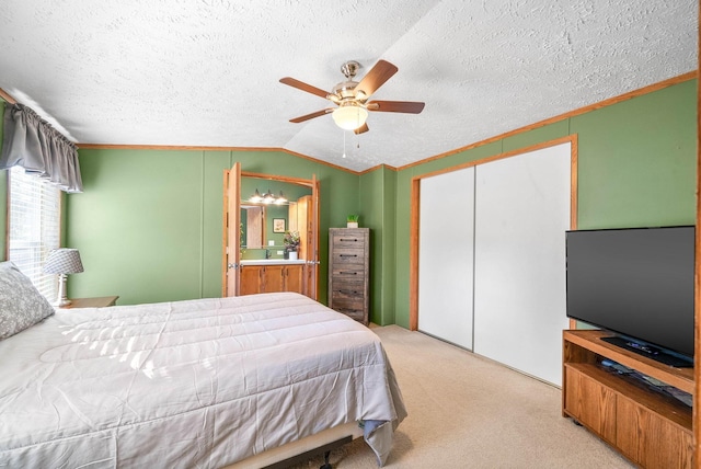 bedroom featuring ornamental molding, a closet, carpet floors, ceiling fan, and vaulted ceiling