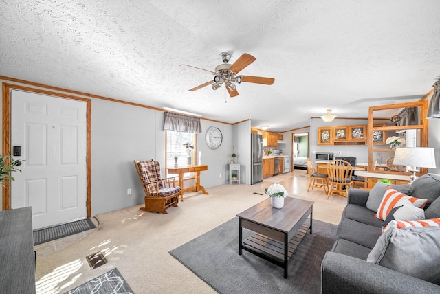 living room featuring lofted ceiling, a textured ceiling, light carpet, and ceiling fan