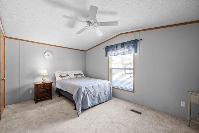 carpeted bedroom with lofted ceiling, ornamental molding, visible vents, and a textured ceiling