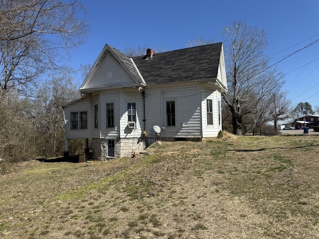 view of front of house with a front lawn and a chimney