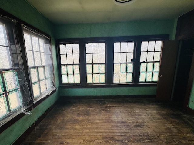 empty room with dark wood-style floors and baseboards