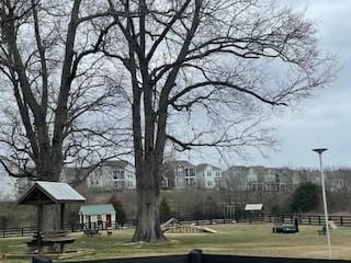 surrounding community with a yard and fence