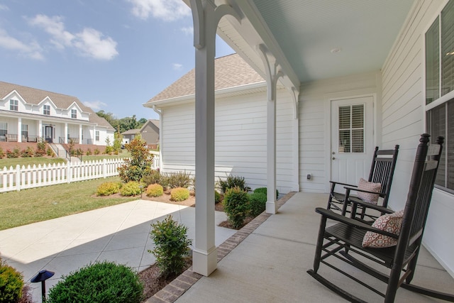 view of patio with a residential view and fence