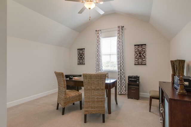 dining room with baseboards, light carpet, and lofted ceiling