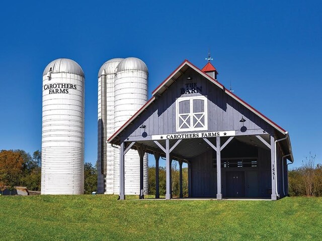 surrounding community featuring an outbuilding, a lawn, and a barn