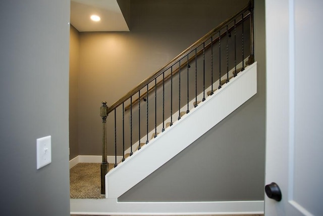 stairway with recessed lighting, baseboards, and carpet