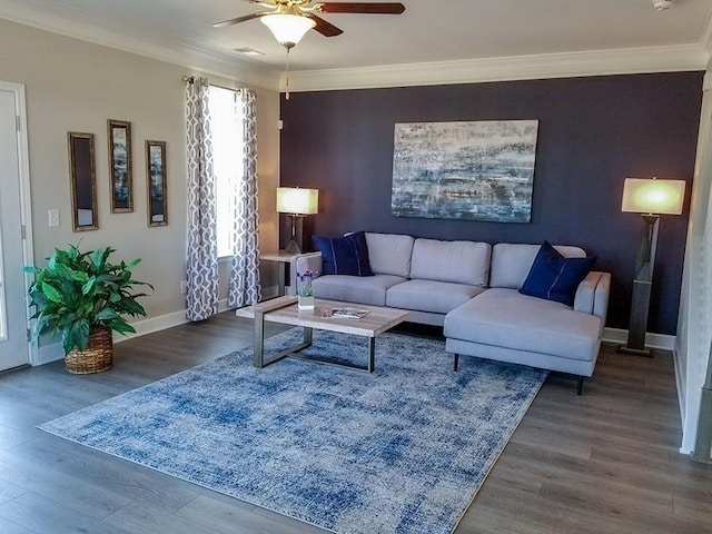 living room featuring a ceiling fan, wood finished floors, baseboards, and ornamental molding