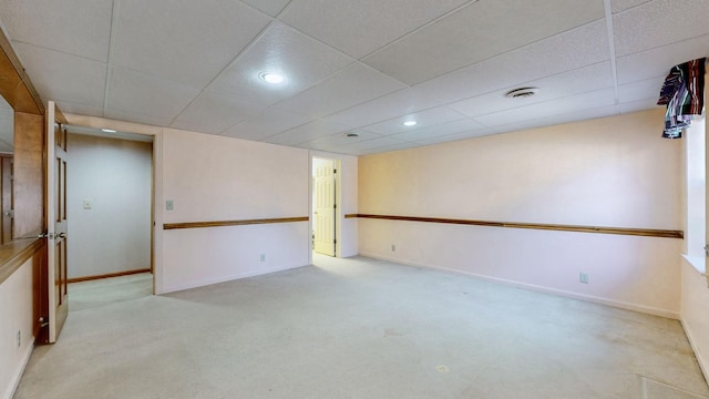 carpeted empty room with a drop ceiling, recessed lighting, visible vents, and baseboards