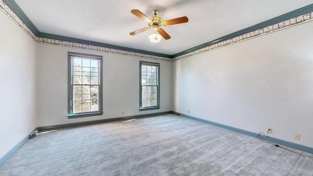 unfurnished room featuring crown molding, baseboards, and carpet floors