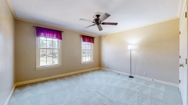 unfurnished room with ornamental molding, a ceiling fan, baseboards, and light carpet