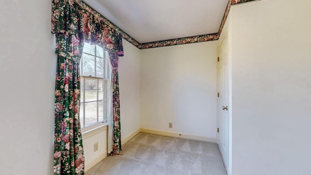 spare room featuring baseboards and carpet flooring