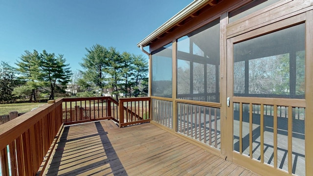 wooden deck with a sunroom