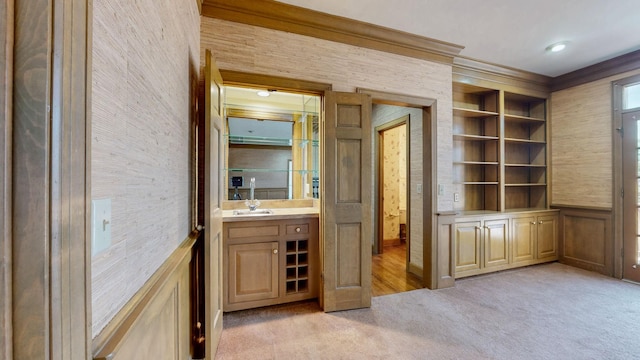 interior space featuring vanity, crown molding, and built in shelves