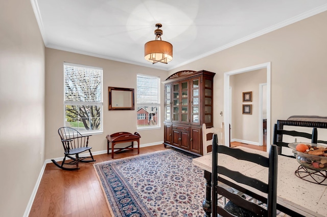 interior space with hardwood / wood-style floors, baseboards, and ornamental molding