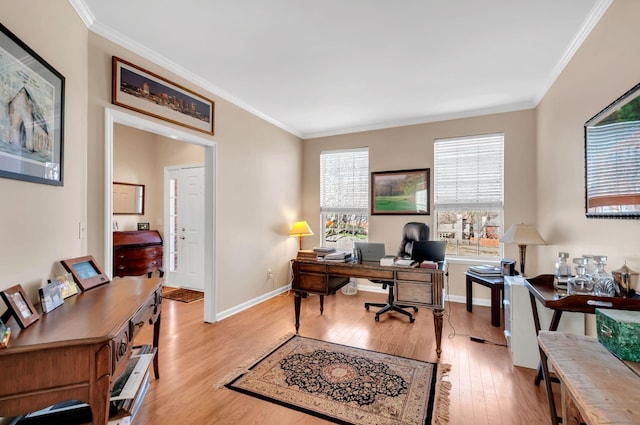 office space with light wood-type flooring, baseboards, and ornamental molding