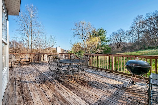 wooden terrace with grilling area and outdoor dining space