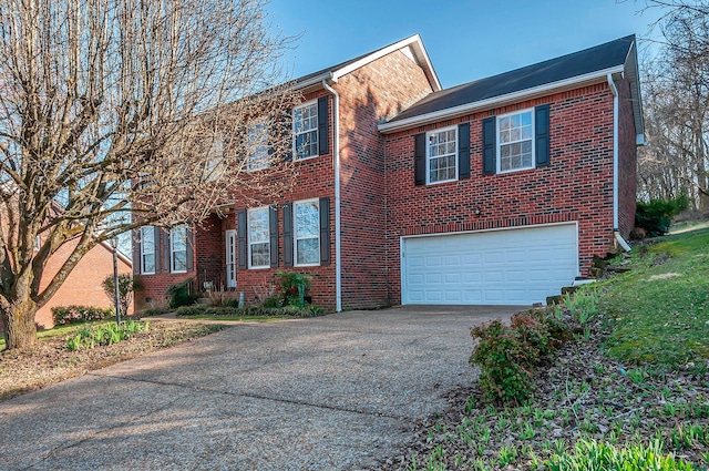 view of front of home with brick siding, an attached garage, and driveway