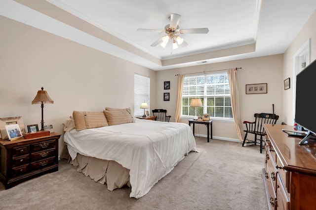 bedroom featuring visible vents, ornamental molding, a tray ceiling, baseboards, and light colored carpet