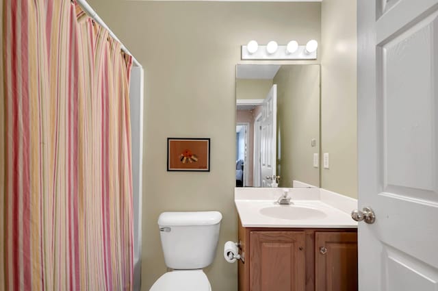 bathroom with a shower with shower curtain, toilet, and vanity