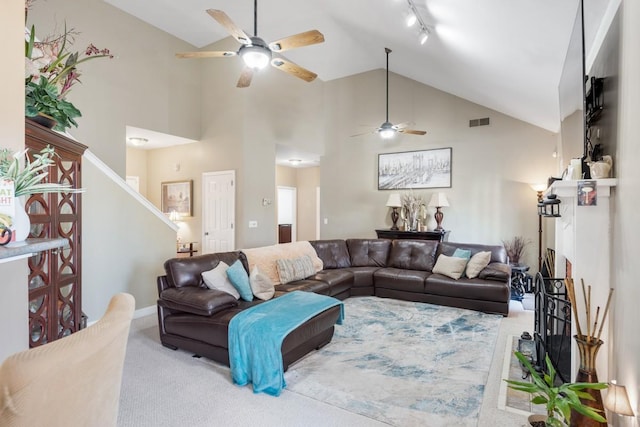 living room with stairway, a ceiling fan, visible vents, track lighting, and carpet