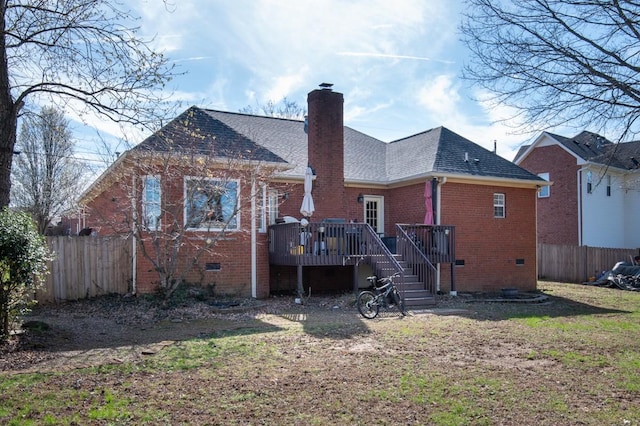 back of property with fence, a wooden deck, stairs, brick siding, and a shingled roof