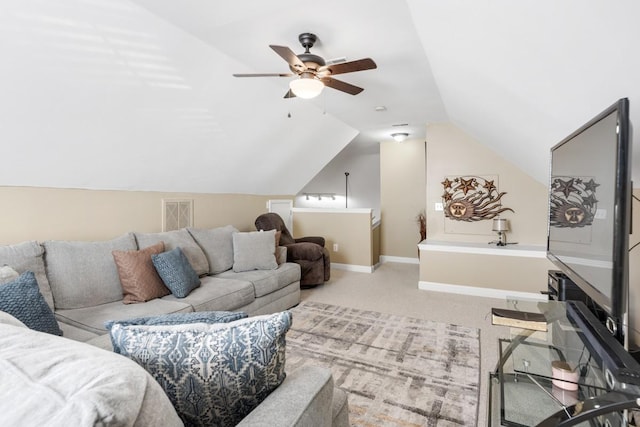 carpeted living area with baseboards, lofted ceiling, visible vents, and a ceiling fan