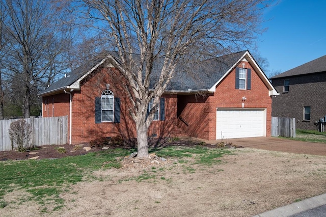 view of front facade with brick siding, driveway, a garage, and fence