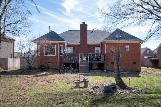 back of house with fence, a wooden deck, crawl space, brick siding, and a chimney