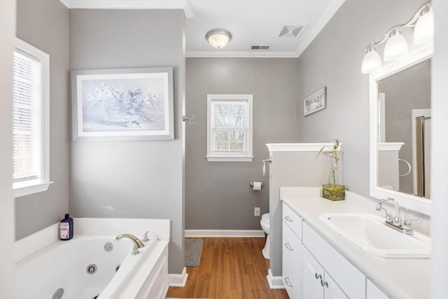 full bathroom featuring vanity, a tub with jets, wood finished floors, baseboards, and ornamental molding