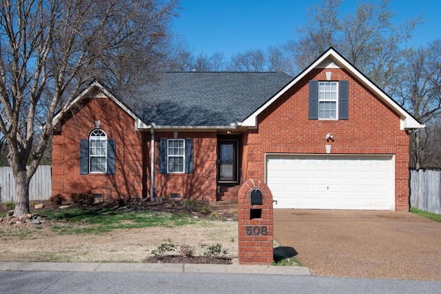 view of front facade with brick siding, driveway, a shingled roof, and fence
