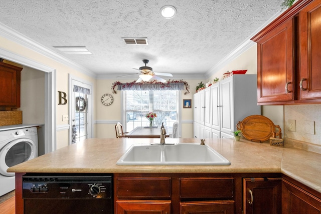 kitchen featuring dishwasher, washer / clothes dryer, light countertops, and a sink