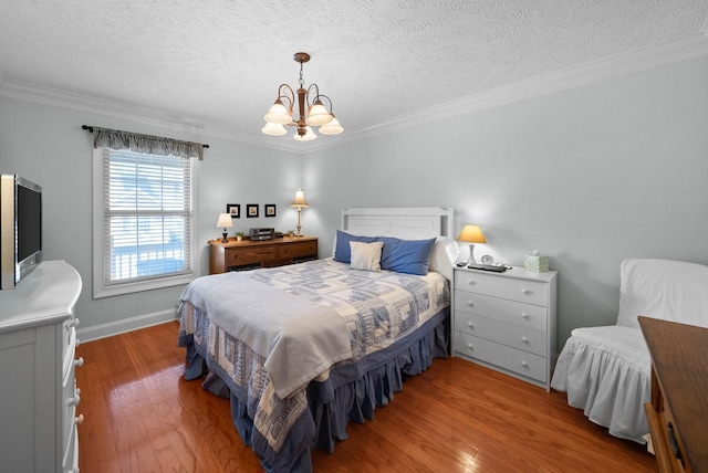 bedroom featuring wood-type flooring, a textured ceiling, an inviting chandelier, and crown molding