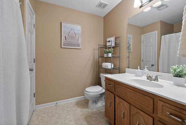 bathroom with vanity, toilet, baseboards, and visible vents