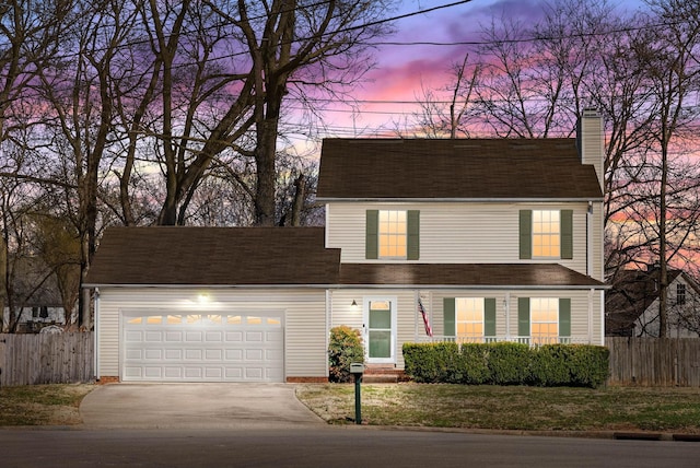 view of front facade featuring a garage, a chimney, driveway, and fence