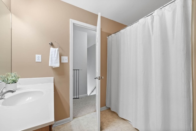 bathroom with vanity and baseboards