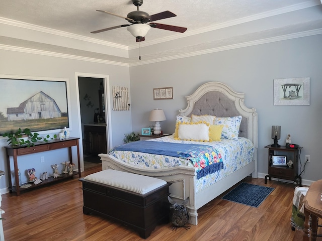 bedroom with ceiling fan, baseboards, wood finished floors, and ornamental molding