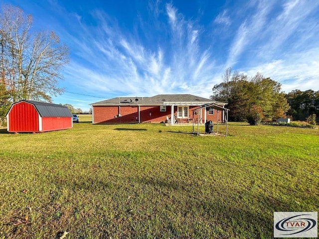 back of house with an outdoor structure and a yard