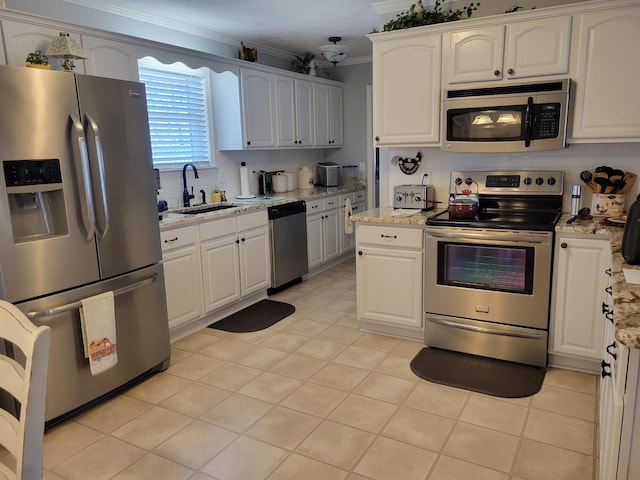 kitchen featuring a sink, backsplash, appliances with stainless steel finishes, and crown molding