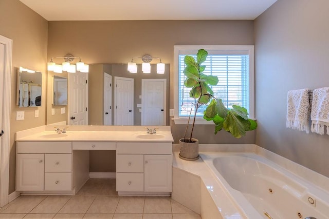 bathroom featuring tile patterned floors, double vanity, a whirlpool tub, and a sink