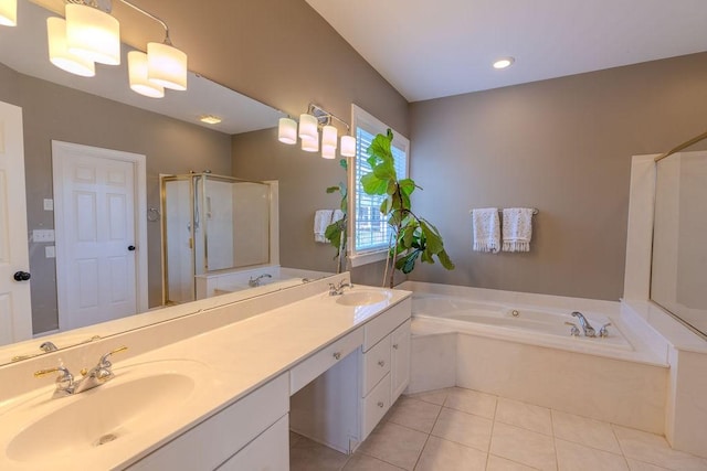 full bath featuring tile patterned floors, a garden tub, a stall shower, and a sink