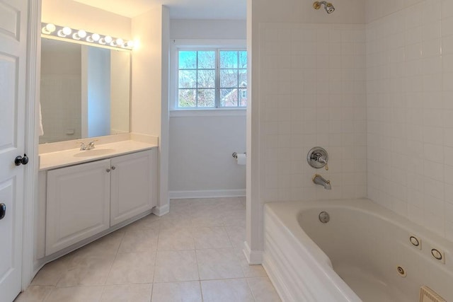 bathroom with tile patterned floors, baseboards, vanity, and  shower combination