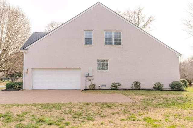 view of home's exterior with concrete driveway, a yard, and a garage