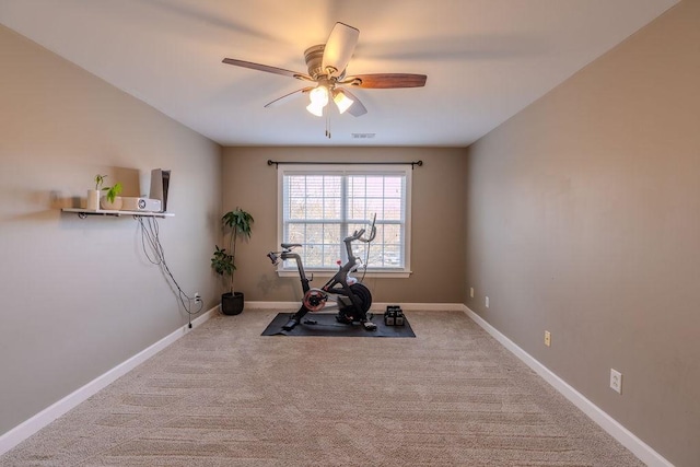 exercise room with baseboards, carpet floors, visible vents, and a ceiling fan