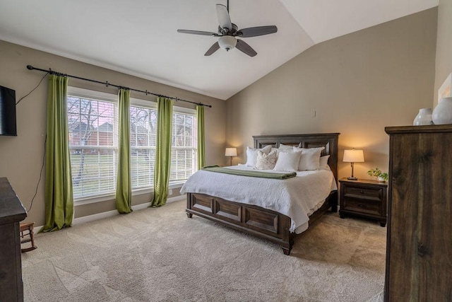 bedroom with vaulted ceiling, baseboards, carpet floors, and ceiling fan