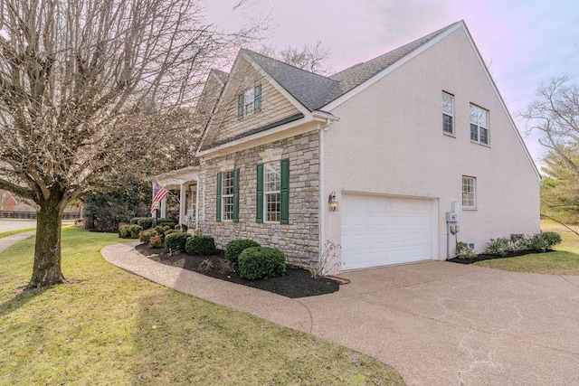 view of home's exterior with driveway, an attached garage, a shingled roof, stone siding, and a lawn