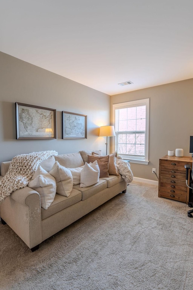 living room with visible vents, baseboards, and carpet flooring