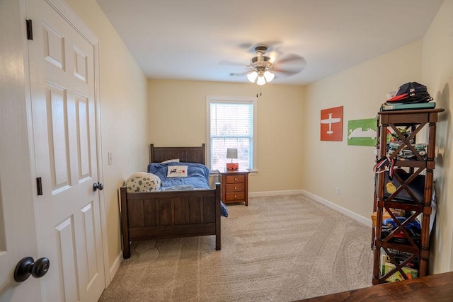 bedroom featuring a ceiling fan, light colored carpet, and baseboards