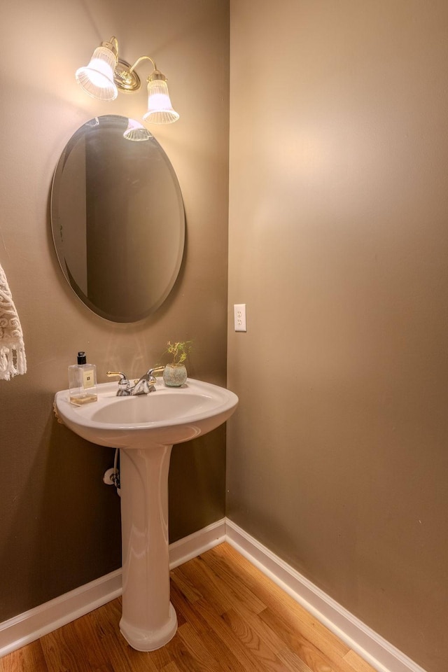 bathroom featuring wood finished floors and baseboards